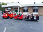man driving kids on a small train