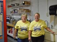 two people smiling in a kitchen