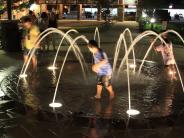 children playing in water fountain