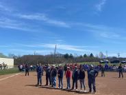 group of people lined up on baseball field