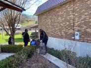 people cleaning up garden