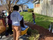 people cleaning up garden