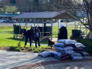 people cleaning up garden