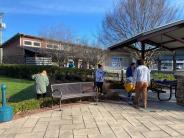 people cleaning up garden