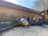 people cleaning up garden