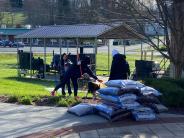 people cleaning up garden