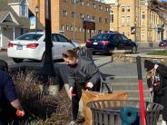 people cleaning up garden