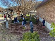 people cleaning up garden