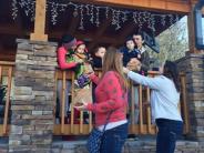 people hanging christmas lights